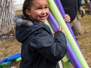 girl with pool noodles